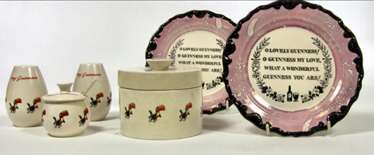 Left, a Carltonware pottery three-piece Guinness advertising condiment set decorated with the toucan and worded in orange ‘My Goodness – My Guinness,’ next to a matching stilton cheese dish and cover. The pink luster plates are worded ‘Oh Lovely Guinness! Oh Guinness My Love, What a Wonderful Guinness You Are!’ As an auction lot, they would be estimated at £150-200. Photo: The Canterbury Auction Galleries.
