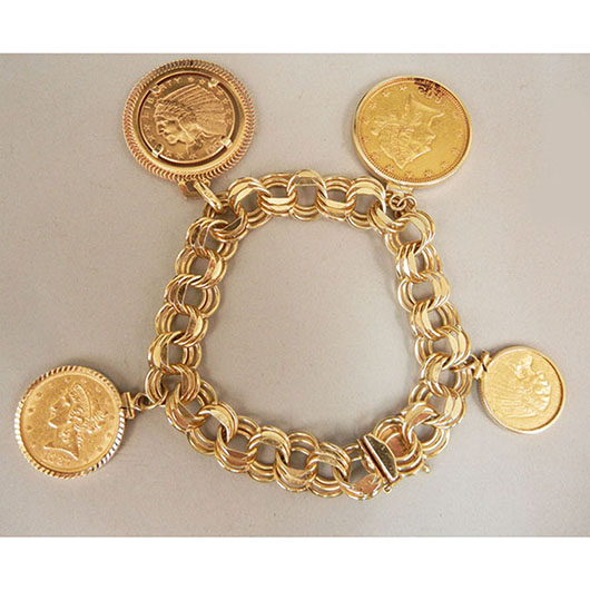 14K gold charm bracelet with four antique US gold coins on gold bezels. Coins include: 1902 $10 Liberty head, 1909 $5 Indian Head, 1911 $2.50 Indian Head, 1887 $5 coin. Stephenson’s Auctioneers image
