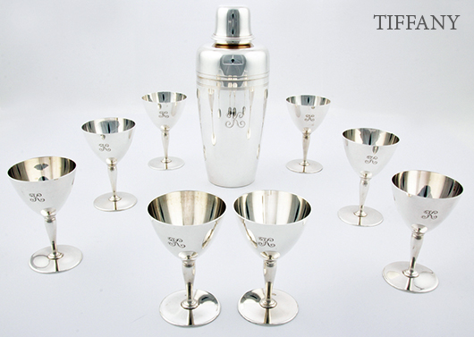 Tiffany & Co. sterling silver cocktail service consisting of cocktail shaker with strainer and jigger cap, marked 2 Pints, 22422 L; and eight matching goblets marked 18885 L. Set comes with original fitted box. Material Culture image