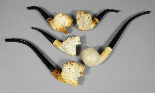 A group of barely used 20th century meerschaum pipes, carved respectively with the heads of a leopard, bison, lion and grizzly bear, the latter with churchwarden stem; the fifth plain, all with fitted cases. They sold together for £160. Photo: The Canterbury Auction Galleries