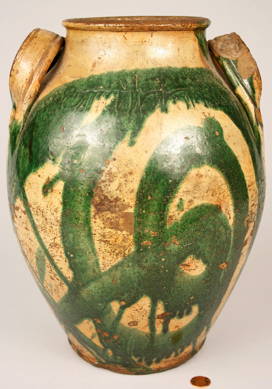 The potting skill of Christopher Haun can be clearly seen in the graceful shape of this 13-inch high jar with attached loop handles. The jar, covered with cream slip decorated with an abstract design in green, sold for $36,800 four years ago. Courtesy Case Antiques