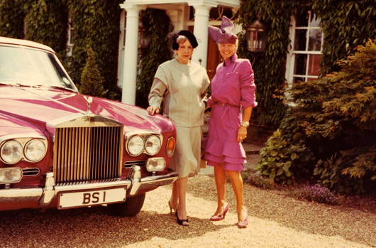 Hannelore Smart (right) wearing the Mugler dress in lot 346 standing next to her Rolls Royce, which is painted a matching shade of magenta. Estimate: £150-250. Kerry Taylor Auctions image.