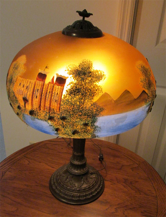 Early 20th century reverse-painted-on-glass lamp with scene of castle on a lake. Estate of Elizabeth and Donald Bates. John W. Coker image