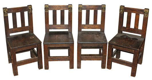 Set of four Arts & Crafts pub chairs with bronzed adornments of monks’ heads, est. $600-$800. Mosby & Co. image