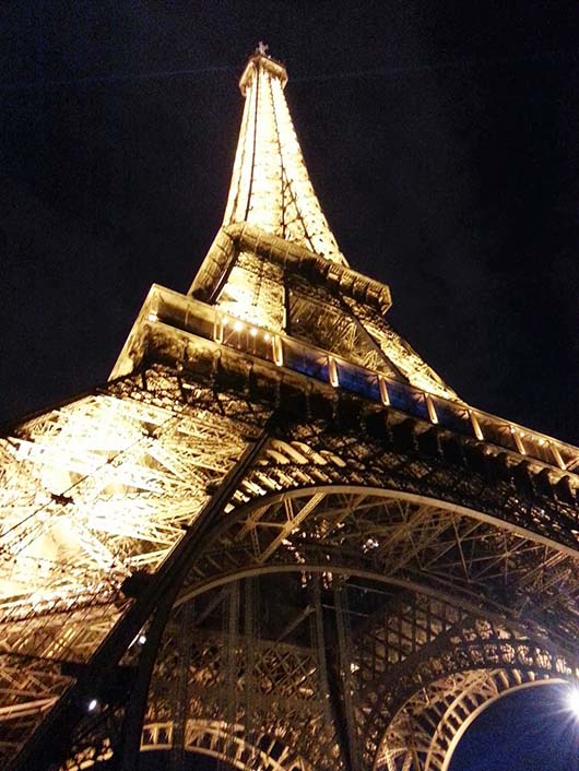 Visitors can now get a unique view from the lower level of the Eiffel Tower, seen here illuminated at night. Image by Mark.thurman92. This file is licensed under the Creative Commons Attribution-ShareAlike 3.0 Unported license.