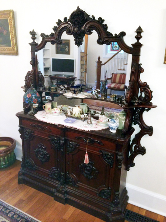 Monumental 72 inch tall by 60 inch wide mirrored-back sideboard, heavily carved with original finish, by Belter or Meeks. Tim’s Inc. Auctions image