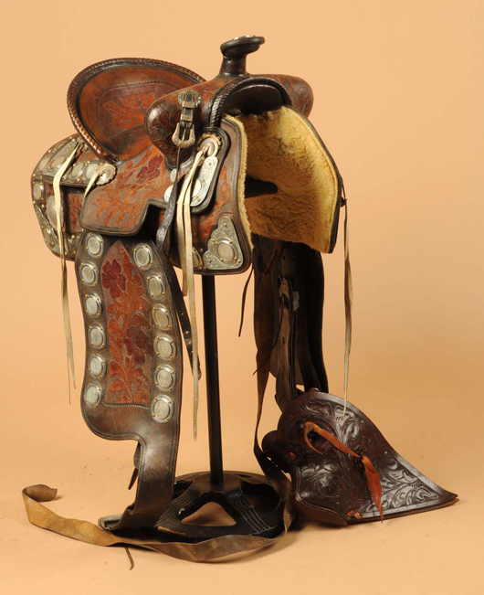 Nickel-silver mounted saddle made by Newell Saddle Shop, St. Louis, Mo., circa 1920-30s, silver dollars mounted in pommel, some sterling mounts, decorations in skirting, est. $6,000-$8,000. Morphy Auctions image