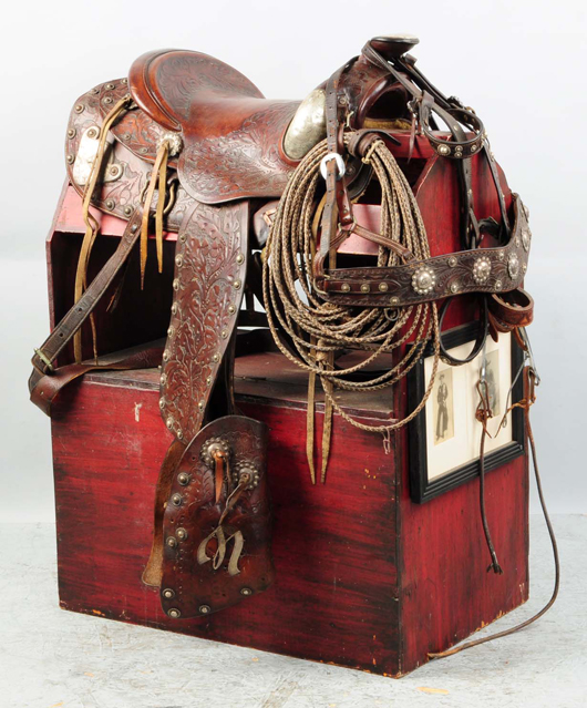 Beautifully tooled leather Western saddle that belonged to cowboy film star Tom Mix, fancy hand-tooled ‘M’ on tapaderos, est. $6,000-$8,000. Morphy Auctions image
