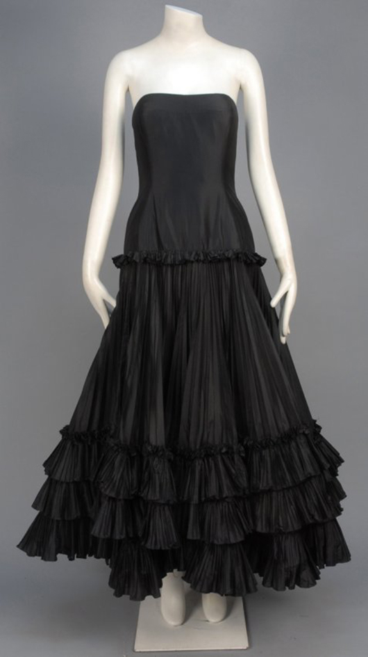 Oscar de la Renta black silk taffeta ball gown having boned bodice with padded bust, slightly dropped waist, and layered full skirt with accordion pleats and ruffles. This dress will be sold at a Charles A. Whitaker Auction Co. auction on Nov. 1. Image courtesy of LiveAuctioneers.com and Charles A. Whitaker Auction Co.
