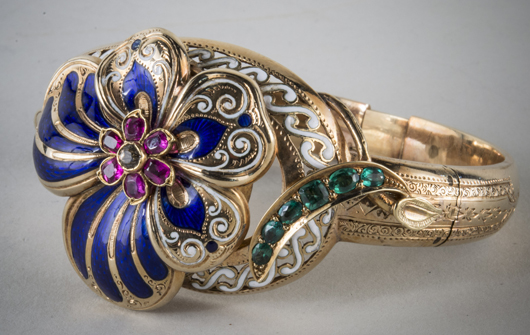 Gold and enamel bangle, 14K yellow gold with a white and cobalt blue enameled flower and emerald and ruby accents. Price realized: $5,400. Capo Auction image
