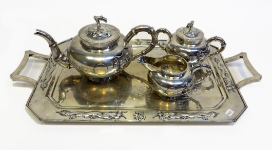 Chinese silver tea service featuring a handled tray, teapot, sugar and creamer, with bamboo edging. Price realized: $5,100. Gordon S. Converse & Co. image