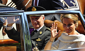King Philippe and Queen Mathilde wave to the crowds in Brussels after Philippe's swearing in as new Belgian monarch in July 2014.