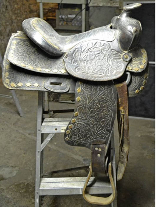 Brown leather Western saddle, 14in with stirrups and tack. Est. $120-$250. Stephenson’s image