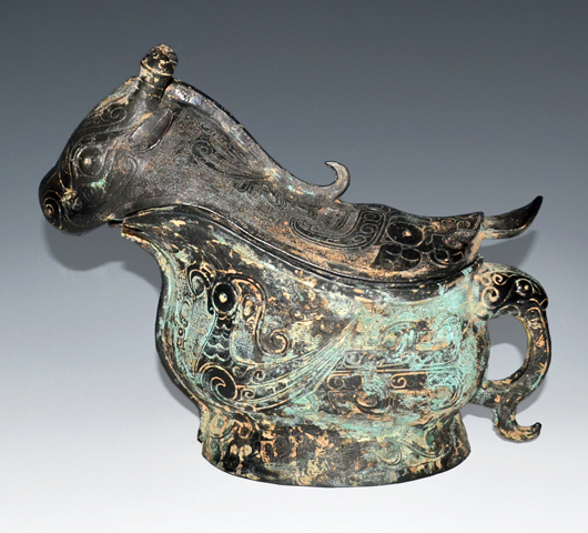 This archaic bovine form gong (wine vessel) with bulging eyes, horns and tongue emanating from the rear is of the Late Shang Dynasty and similar to one in the Shanghai Museum. Estimate: $60,000-$80,000. Gianguan Auctions image