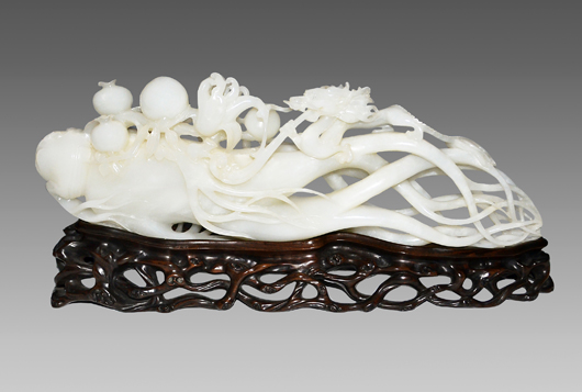 A Hetian jade carving of lingzhi with Dragon and Peach is composed of symbols of longevity. The translucent stone is of an even white tone, 15 1/2 inches long. Estimate: $40,000-$50,000. Gianguan Auctions image