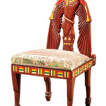 This unusual chair is in the Egyptian Revival style. The carved wooden chair-back of a jackal-headed man-bird and the geometric trim are borrowed from ancient Egyptian art. It sold for $777 at Neal Auction Co. in New Orleans.