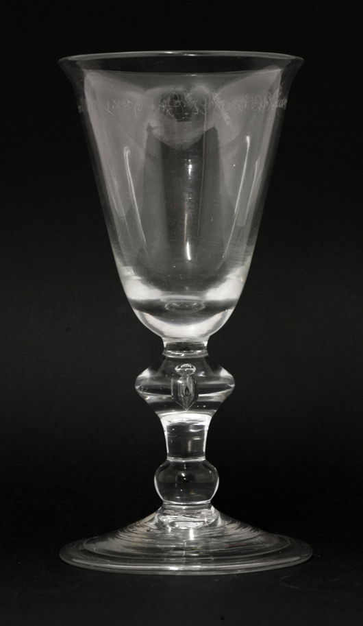 Baluster goblet, circa 1715, the engraving dated 1728, inscribed in diamond point around the bowl 'Nov'r ye 11: 1728: for Master Shaw Holth in a Bumper,' the foot inscribed 'L. Waters' (or possibly Watson). Estimate: £800-£1,200. Sworders image