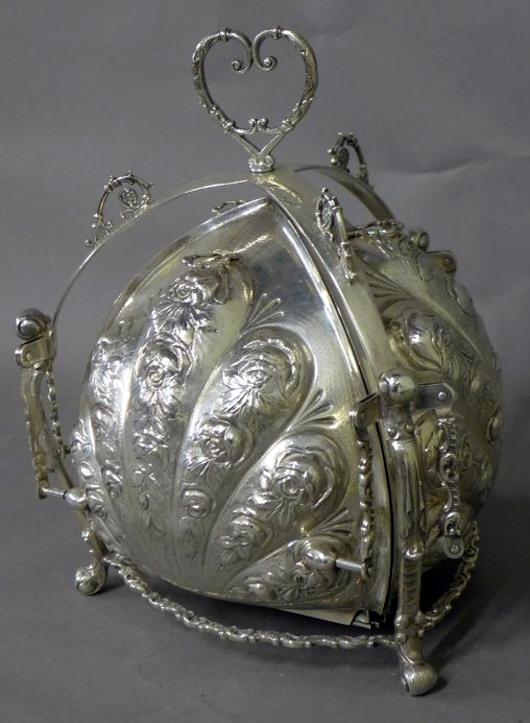 From an extensive selection of sterling silver, a heavily chased repousse bun warmer with three hinged compartments, stamped: Sterling, J.V.H., G.E.S.G., Germany. Est. $1,200-$1,500. Sterling Associates image