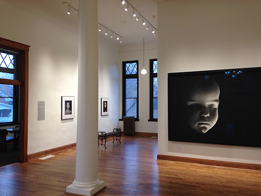 A Robert Longo charcoal portrait of a baby, 2007, is displayed in the former Carnegie library. Image courtesy of Clarinda Carnegie Art Museum