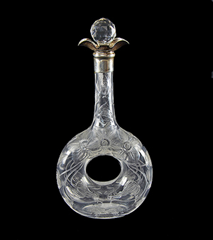 A good rock crystal glass decanter engraved with a Wisteria design by Stevens and Williams. The silver mount is hallmarked for London 1904. Sold for £340. Photo Ewbank’s Auctioneers