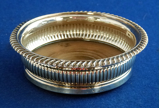 A handsome William IV silver gadrooned coaster with wood base (Sheffield 1831) sold for £280. Photo Ewbank’s Auctioneers