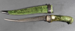 This East Indian Mughal-type khanjar dagger with a jade hilt carved in the form of a parrot features inlaid red glass eyes. Clars Auction Gallery image