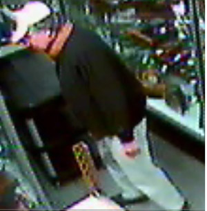 Person of interest seen in video footage taken at the time three pieces were shoplifted from Jeffrey S. Evans' gallery. Image provided by Jeffrey S. Evans