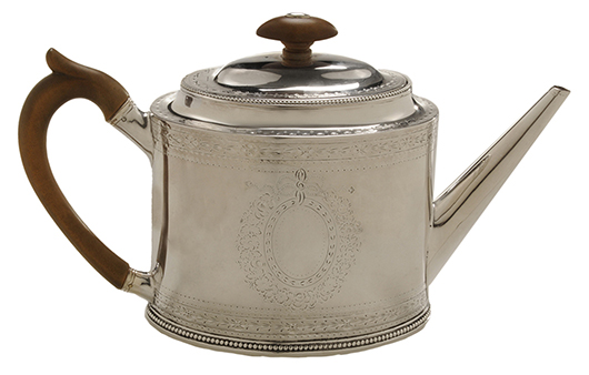 This sterling-silver teapot has a handle and finial made of pear wood and a silver border with floral engravings. The side has an engraved heraldic design possibly identifying her customer. Auction price, $2,832.