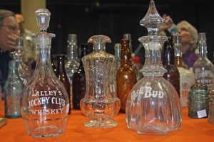 Some of the saloon bar whisky bottles shown by Paul Van Vactor. From the left, they are inscribed Lalley's Jockey Club, Thorne's Whisky and Rosebud.