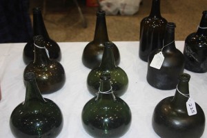 Some of the early shaft and globe and onion wine bottles shown by Charlie Livingston from Tampa, Florida. Those without the natural shine have been lifted from the seabed