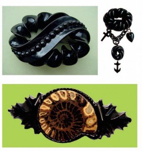 Clockwise, a Whitby jet brooch with carved ribbon border; another set with charms representing faith, hope and charity, and another decorated with a cut and polished ammonite fossil. Photo © Shire Publications 2009