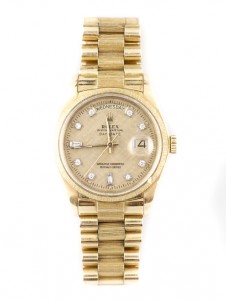Men’s Rolex Presidential 18K yellow gold watch with gold textured bark finish dial with diamond markers. Price realized: $9,000. Ahlers & Ogletree image