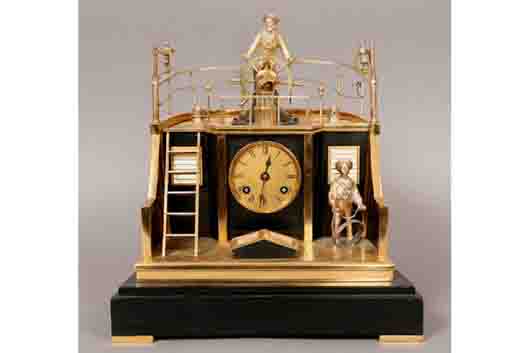 Outstanding 19th century nautical shelf clock by Guilmet of Paris. It has a gilt, silvered and enameled case resting on a black stone base. Image courtesy of LiveAuctioneers.com archive and Kamelot Auction House.