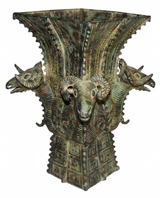 A massive ritual wine vessel decorated with four ram heads. Archaic bronze. Shang Dynasty. Gianguan Auctions Art Gallery image