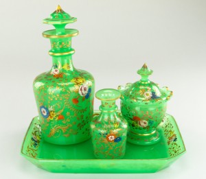 Early 19th century four-piece Bohemian green glass decanter set decorated with gilding and enamel floral paintings. Estimate: $8,000-$10,000. Artingstall & Hind Auctioneers image