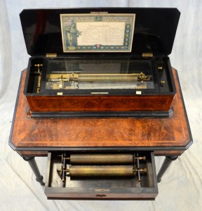J.H. Heller Expression Zither Swiss interchangeable cylinder music box, No. 11093, burl walnut case, on stand with storage drawer, good playing condition. Bunch Auctions image
