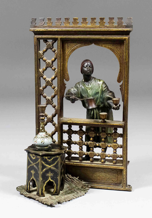 A good late 19th century cold-painted bronze inkstand by Franz Bergman, modeled with an African dispensing coffee at an open window. It measured 8.25 inches and sold for 1,350 pounds. Photo The Canterbury Auction Galleries