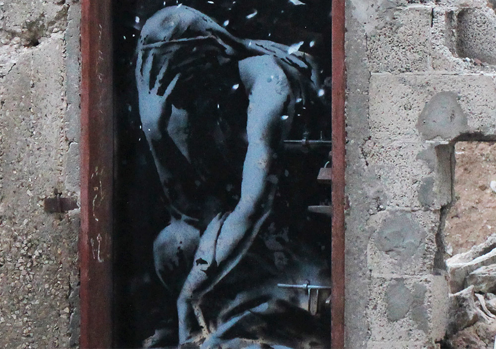 The Banksy artwork on the door of a destroyed home in Gaza shows the Greek goddess Niobe weeping. Image courtesy of banksy.co.uk