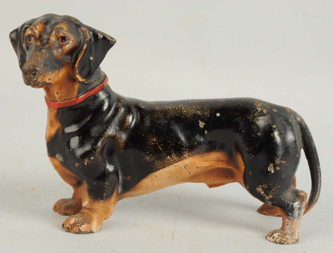 Figural cast-iron Dachshund doorstop, one of dozens offered in the sale that are in the form of dogs, est. $150-$250. Morphy Auctions image
