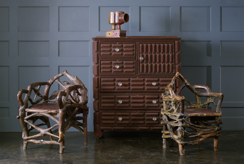 The rustic chairs came from gangster Al Capone's retreat called The Hideout in northern Wisconsin. The tramp art chest is adorned with chip-carved decoration and glass pulls. Wright image
