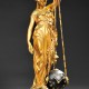 The gilt Ceres, goddess of agriculture, holds a suspended clock that appears to be running without any power source. She is 28 inches high. The clock, made about 1890 in France, was sold by Skinner Auctions of Boston for $5,843.