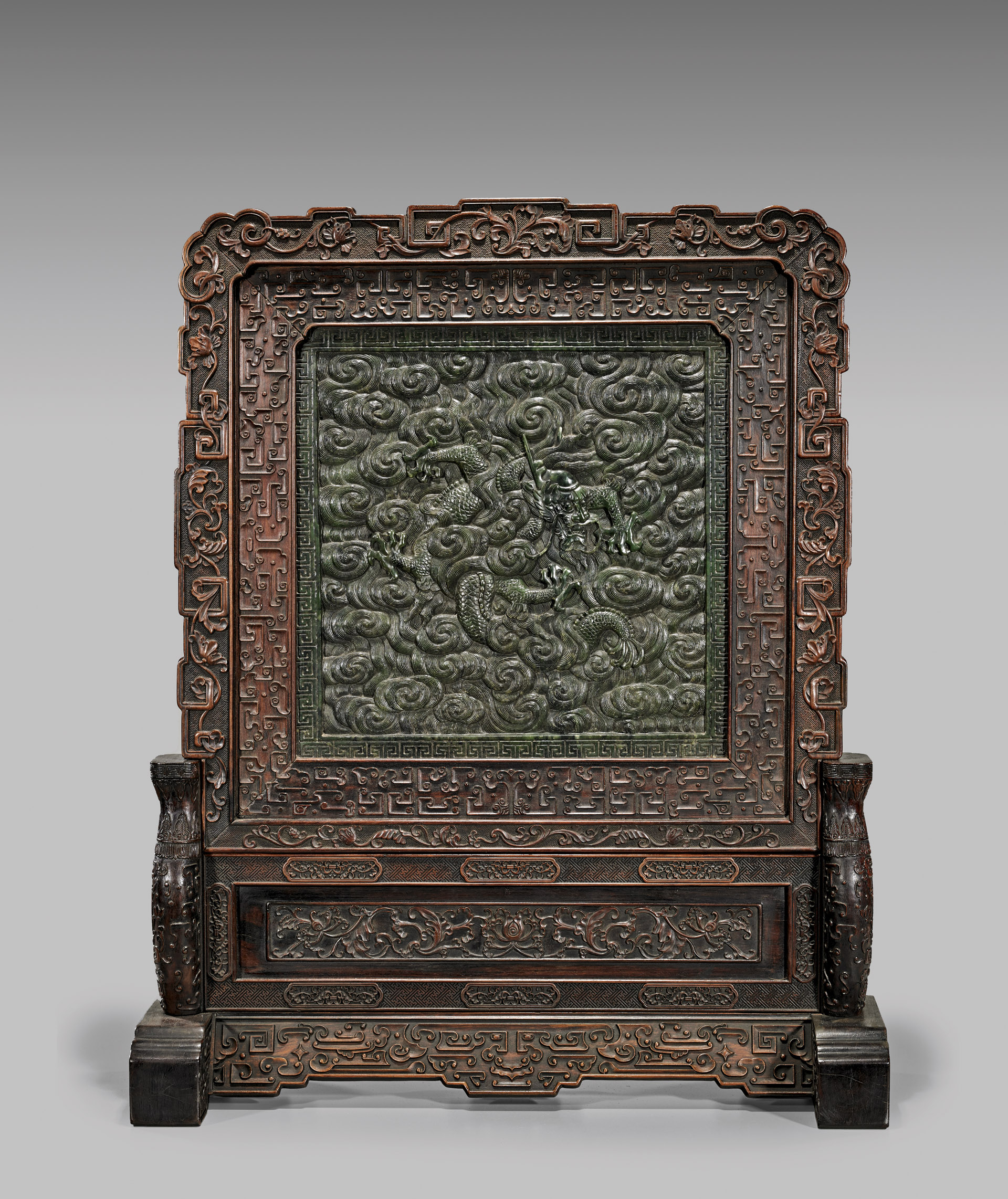 This heavily carved Chinese spinach jade rosewood tablescreen stands 32 inches high. It is estimated at $20,000-$25,000. I.M. Chait Gallery/Auctioneers images
