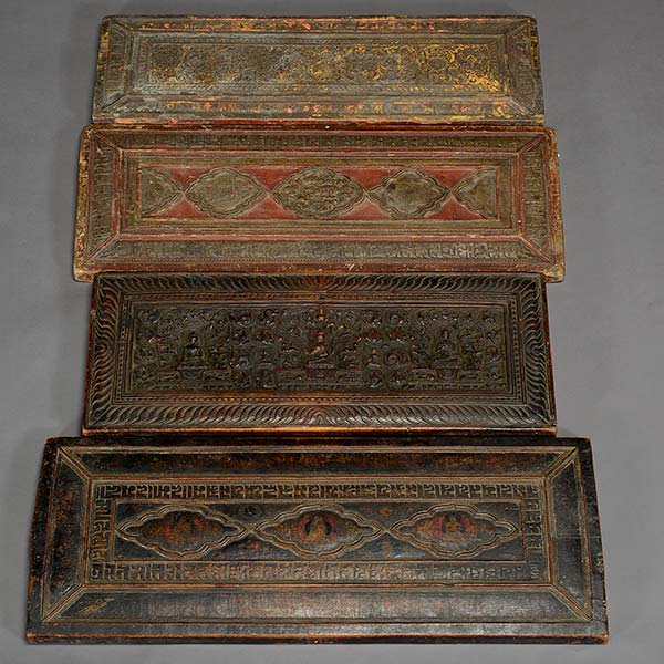 Four Tibetan Buddhist carved wood sutra covers sold for $7,080. Michaan’s Auctions image