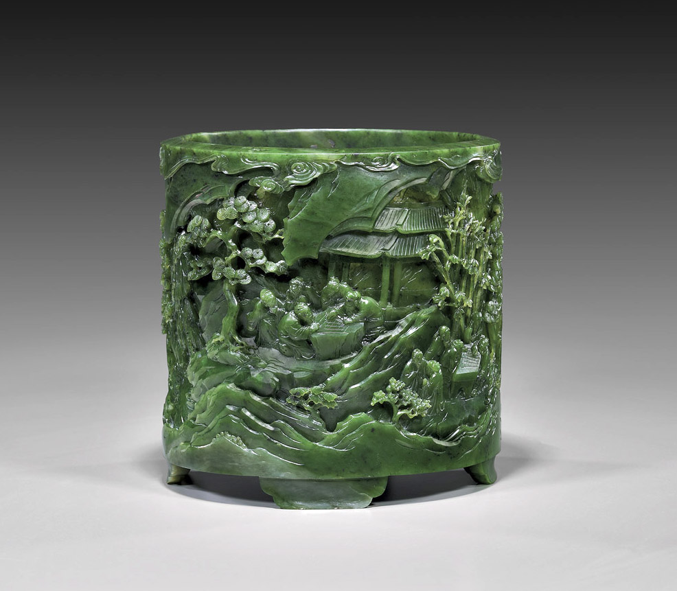 An essential accessory for a scholar’s desk, this brushpot of brilliant green spinach jade, a type of nephrite, is decorated with a mountain forest scene featuring scholars playing chess. The large cylinder, with a earlier Spink & Son Ltd. label on base, sold for $75,000 at an I.M. Chait auction in 2012.  Courtesy: I.M. Chait.