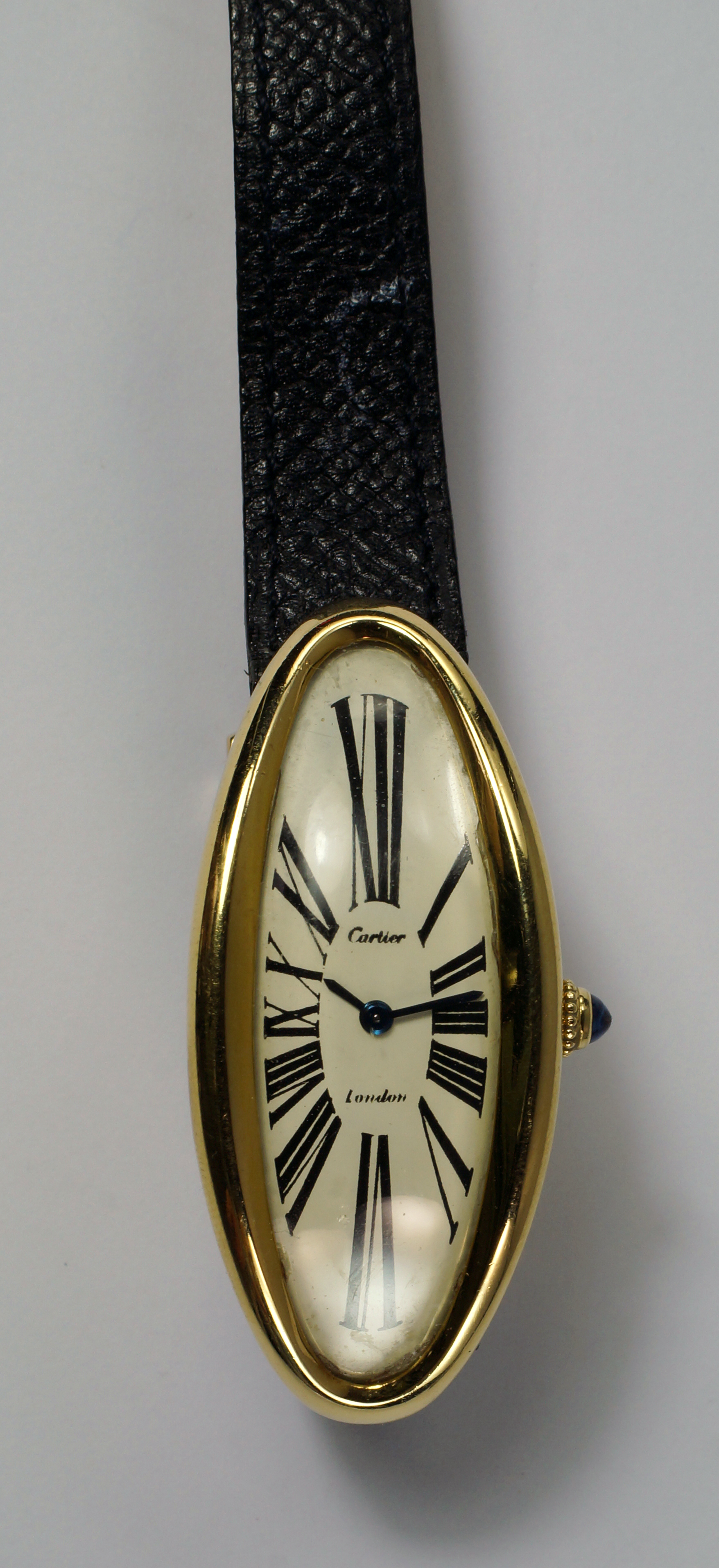 Cartier ladies wristwatch in 18K gold curved and elongated oval case, price realized: £18,450 ($28,354). Roseberys image