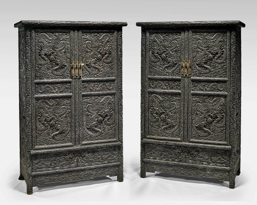 Pair tall Chinese zitan wood cabinets with intricately carved design of writhing dragons, 79 3/4in (est. $10,000-$15,000). I.M. Chait Gallery/Auctioneers