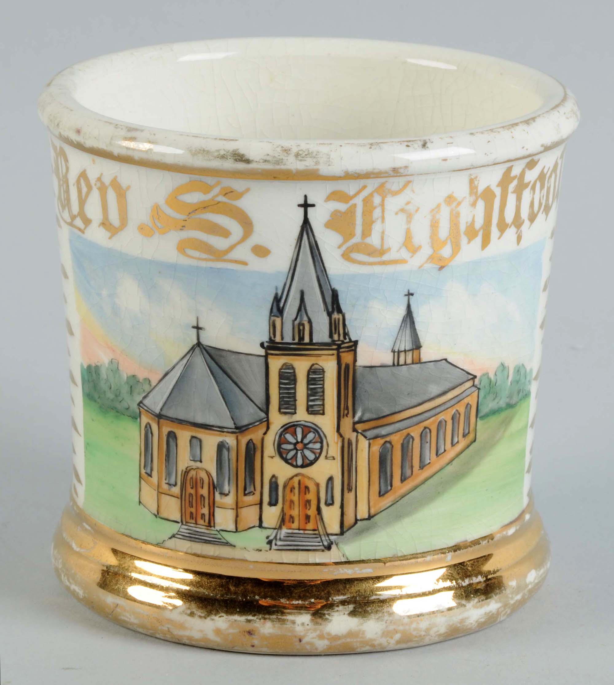 Occupational shaving mug with image of steepled church and the name Rev. S. Lightfoot, est. $600-$900. Morphy Auctions image