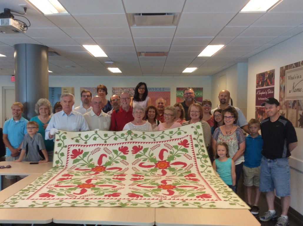 Members of the Myers clan gather around the Civil War-era quilt. Image courtesy of the  International Quilt Study Center and Museum at the University of Nebraska-Lincoln.