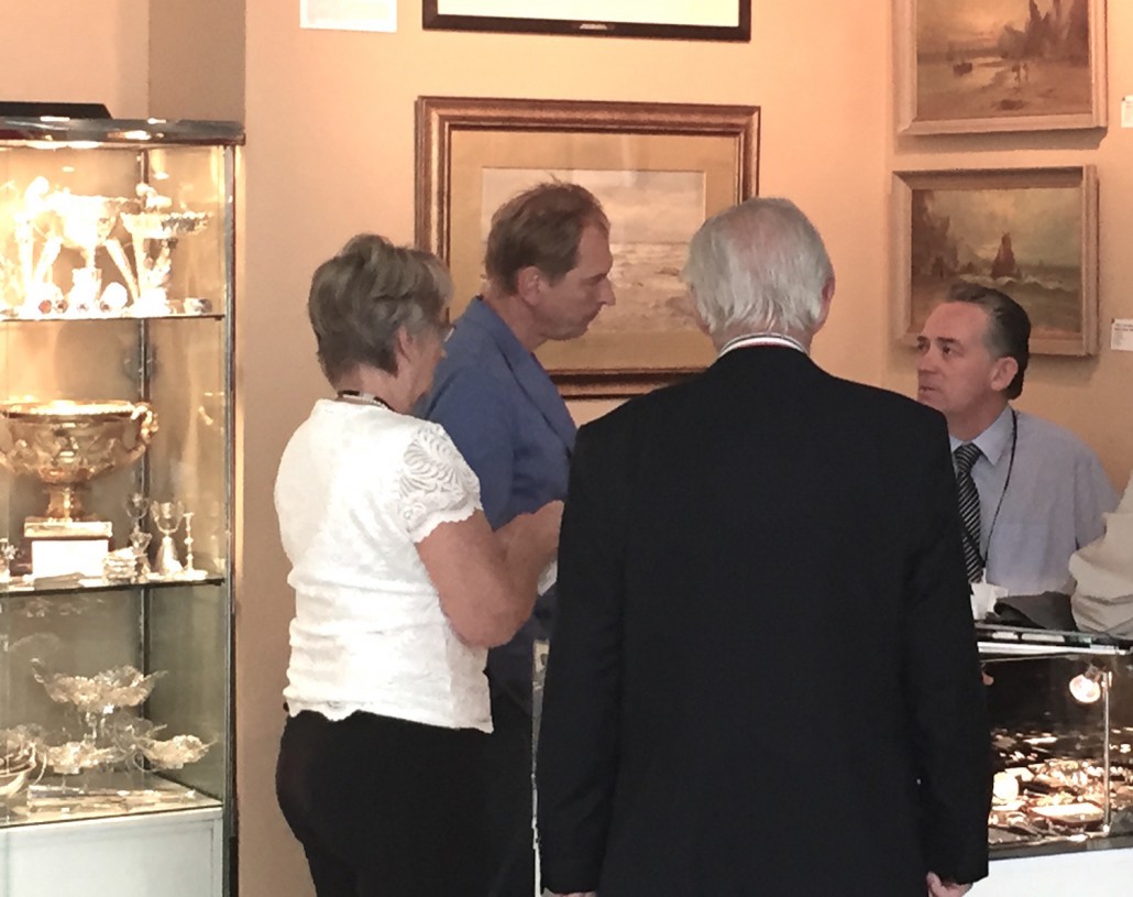 English actor Julian Sands appeared to take particular interest in decorative silver at the Olympia Fine Art & Antiques Fair in June. He favors Irish and Indian works. Image Auction Central News.