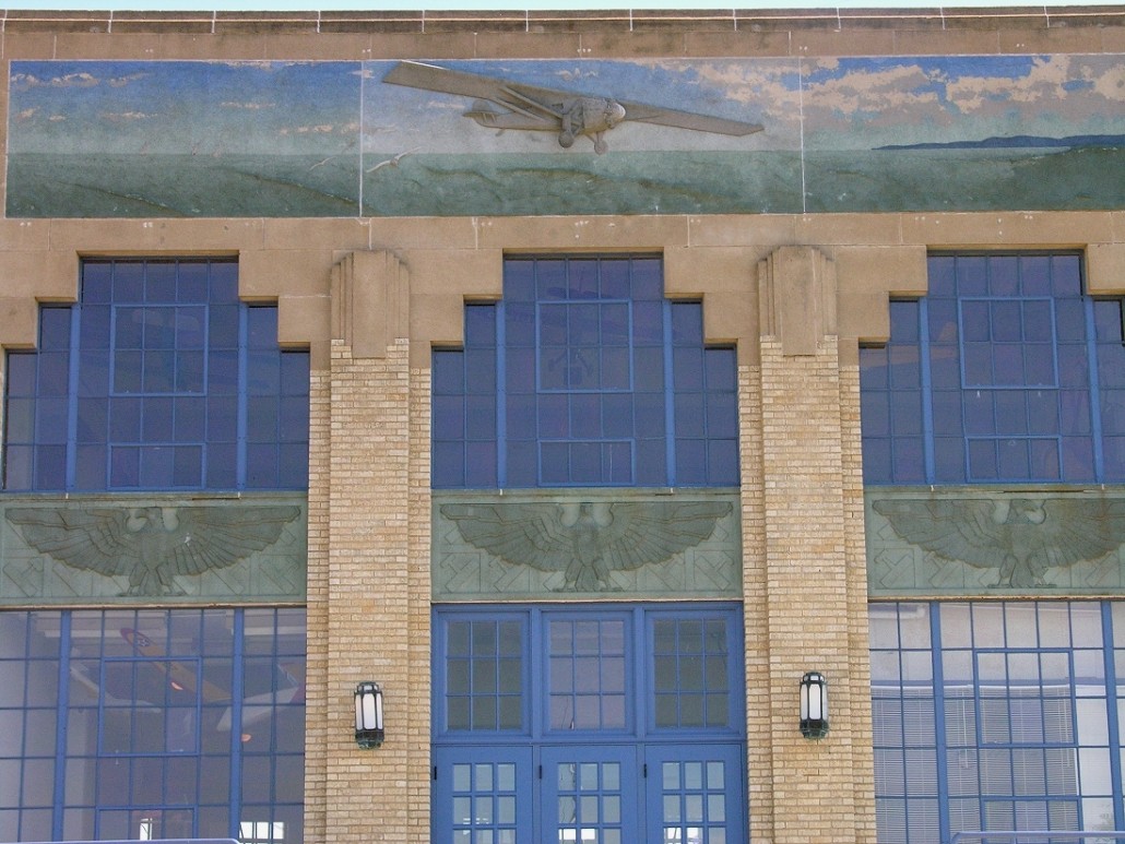 The former Wichita Municipal Airport terminal, which now houses the Kansas Aviation Museum, features a bas-relief of the Spirit of St. Louis crossing the Atlantic above an entrance. Image by David G. Keith. This file is licensed under the Creative Commons Attribution-Share Alike 3.0 Unported license.